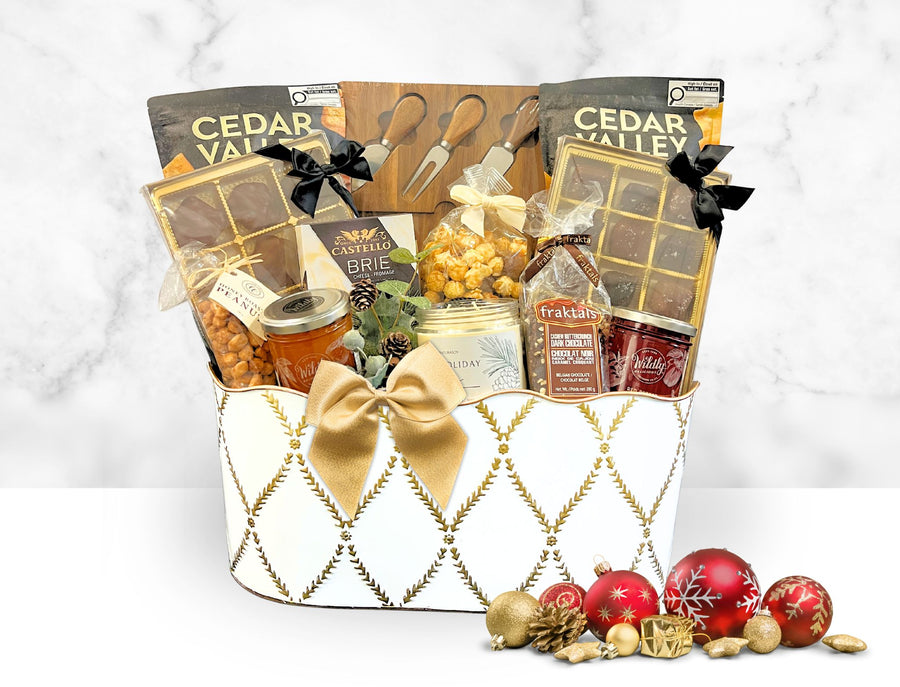 Gift basket with various items including candles, snacks, and decorative elements on a white background.