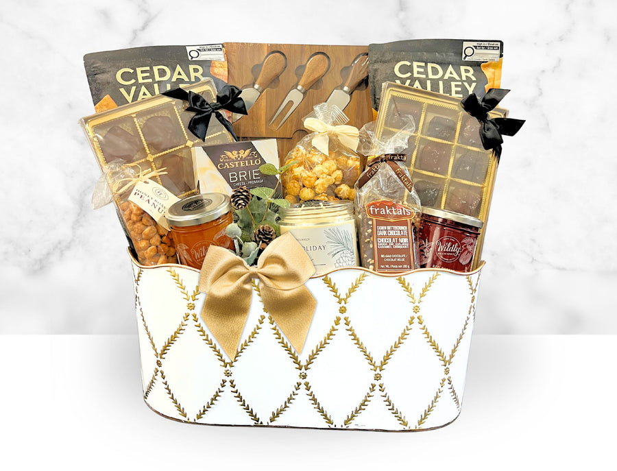 Gift basket with various items including cheese, fruits, and a bottle of wine on a white background