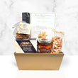 Load image into Gallery viewer, A gourmet gift basket in a gold rectangular tray, featuring Castello Brie cheese, Wildly Sweetened candy, pretzels, rustic olive crackers, and a jar of nuts, set against a white marble background.
