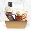 Load image into Gallery viewer, A gourmet gift basket in a gold rectangular tray, filled with assorted snacks and treats including Castello Brie cheese, Wildbeef jerky, pretzels, and Rustic Olive Crackers, set against a white marble background.
