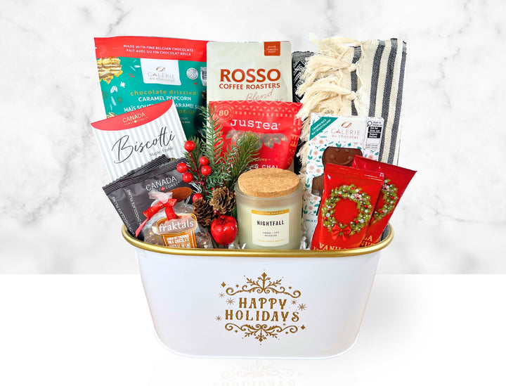 Gift basket with holiday-themed items including coffee, tea, and a candle on a white background.